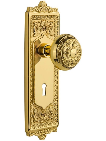 Egg and Dart Door Set with Matching Knobs and Keyhole Single Dummy in Polished Brass.